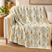 Green Bloom Sofa Throw draped over a sofa