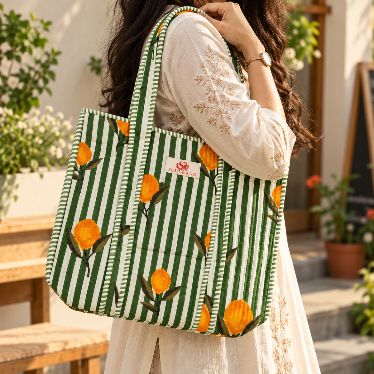 The Sunny Stripes Tote Bag carried on the shoulder